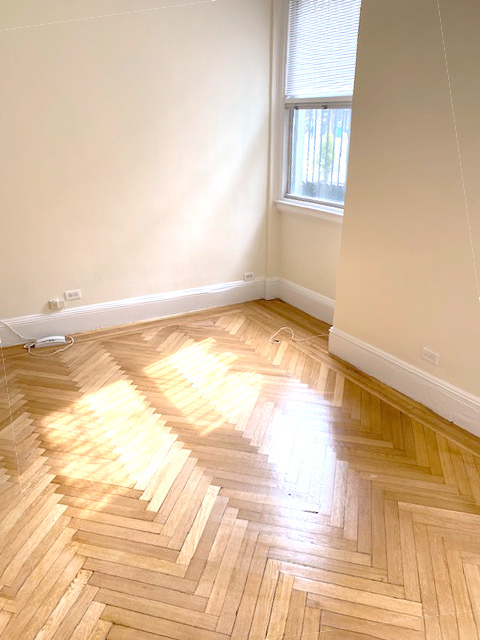 Office space featuring hardwood flooring in a professional setting